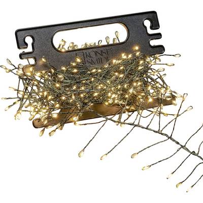 A bundle of warm white string lights wrapped around a black plastic holder, featuring multiple lit bulbs on green wire branches.
