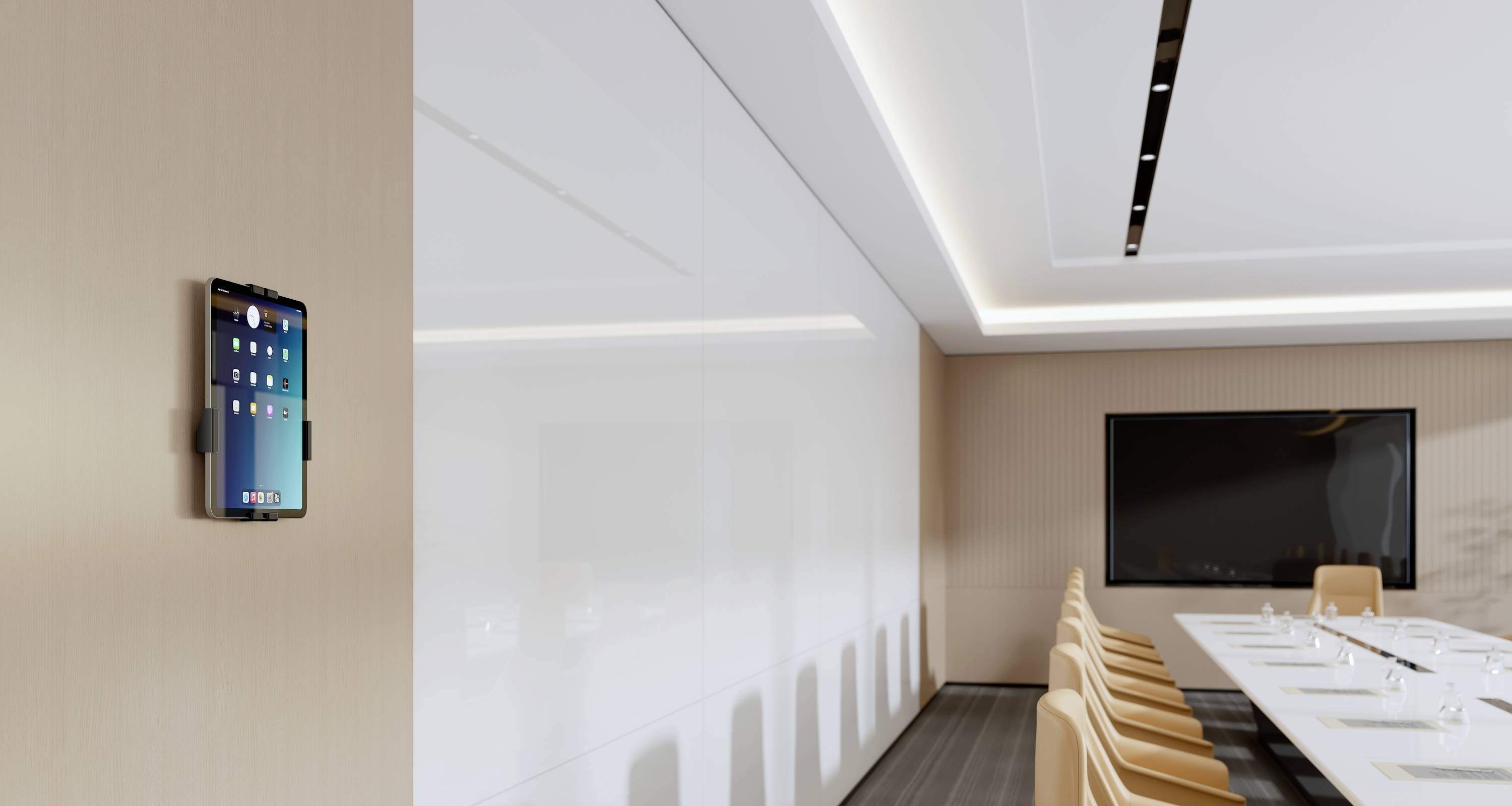 'A modern conference room featuring a long table with chairs, a large wall-mounted screen, and a wall-mounted tablet displaying apps.'