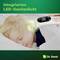 A child sleeps peacefully whilst a thermometer with integrated LED lighting is being used to take measurements.