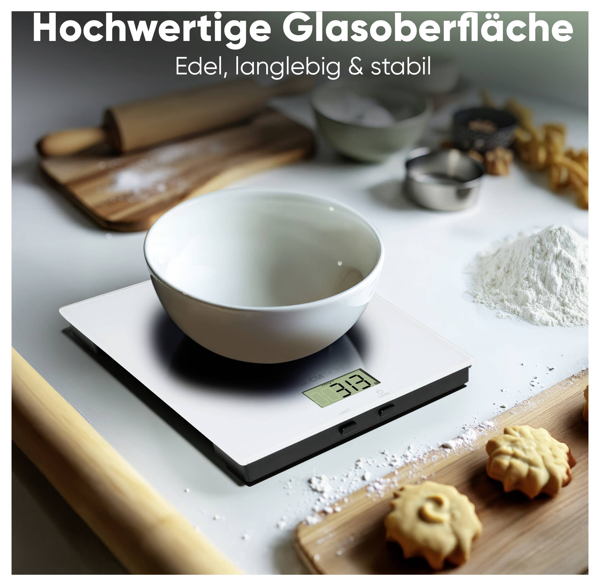 'A digital kitchen scale with a bowl showing 33 grams, surrounded by baking ingredients and tools. Text reads: "Hochwertige Glasoberfläche Edel, langlebig & stabil".'