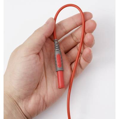 A hand holding a red electrical probe with a flexible wire, used for testing electrical circuits.