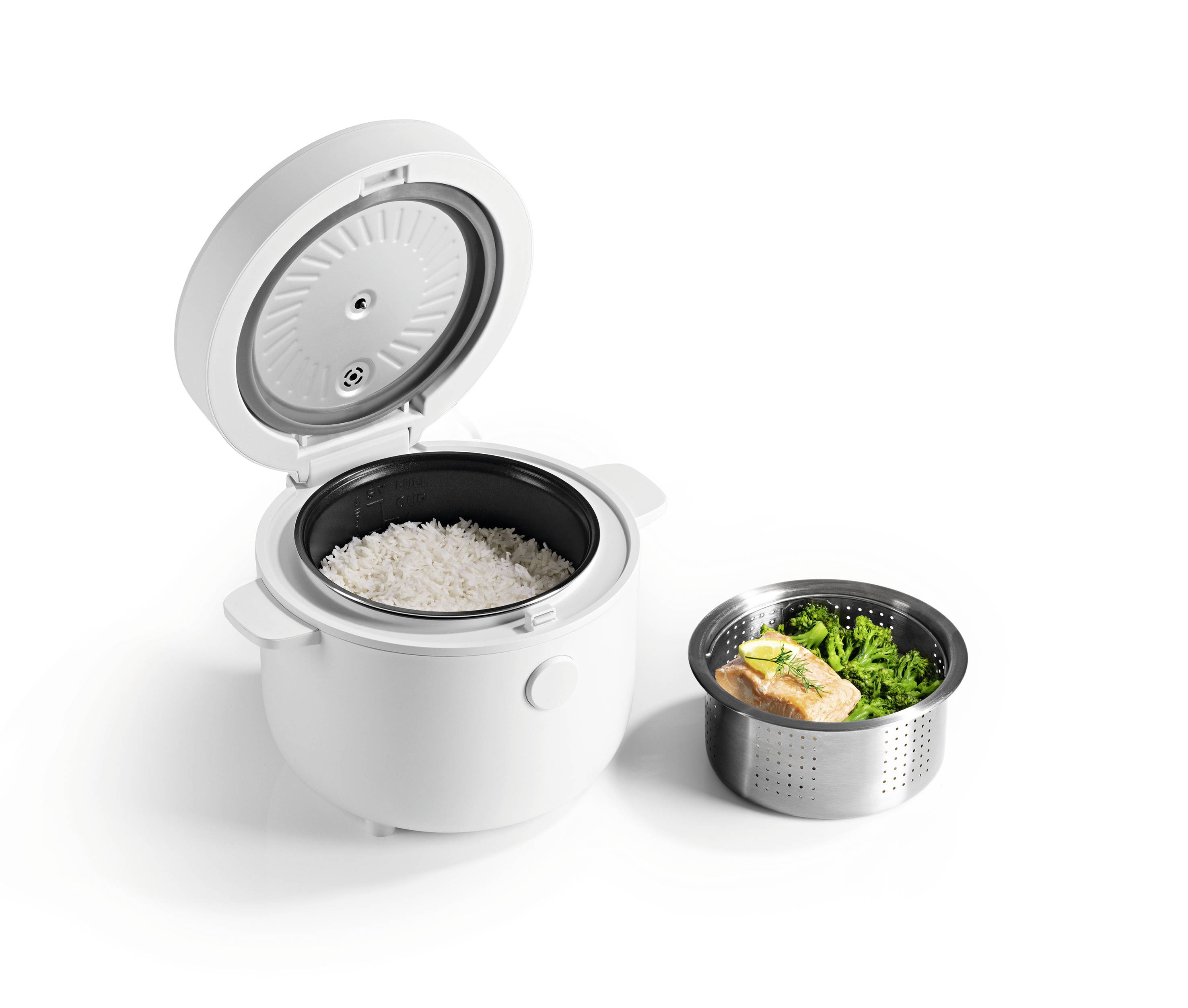 Rice cooker with rice inside, next to a steaming tray holding salmon and broccoli, isolated on a white background.