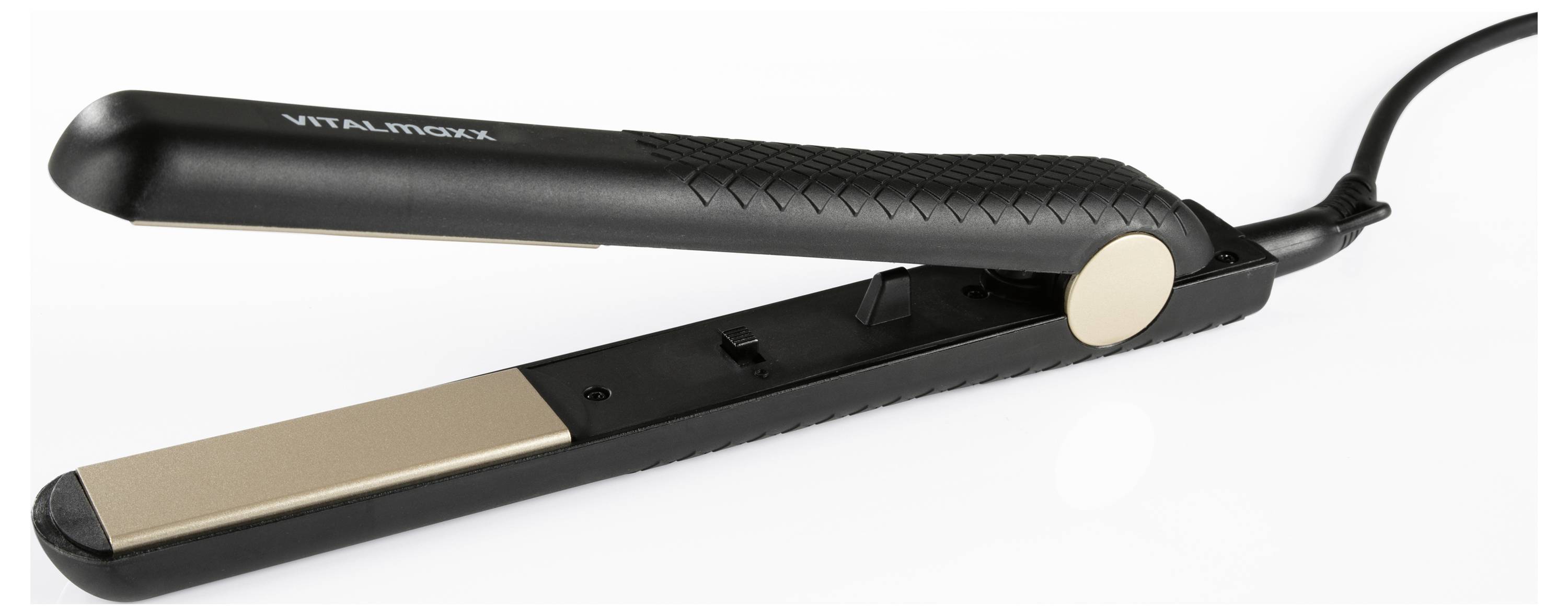 A black and gold hair straightener lies open on a white surface.