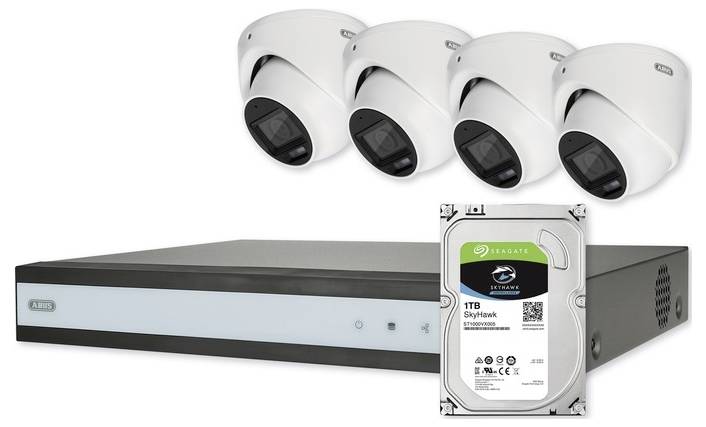 'Security camera system with four dome cameras, a network video recorder, and a 1TB Seagate Skyhawk hard drive for surveillance.'