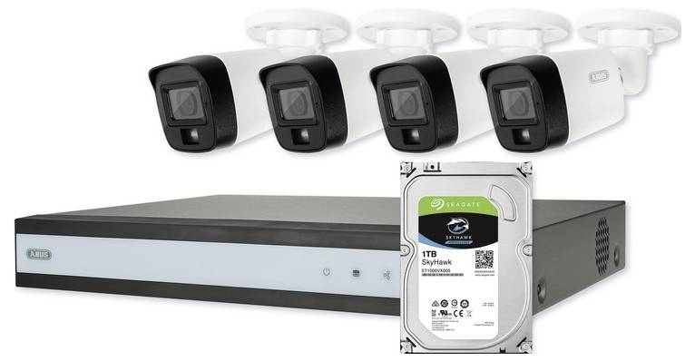 A security system featuring four surveillance cameras, a recorder unit, and a 1TB Seagate Skyhawk hard drive for data storage.