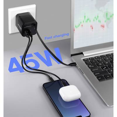 A smartphone and wireless earbuds are plugged into a power adapter labeled '45W' for fast charging, with a laptop displaying a stock chart.