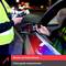 Police officer uses a breathalyzer on a driver in a car at night, displaying a reading. Text reads 'Police-grade measurements'.