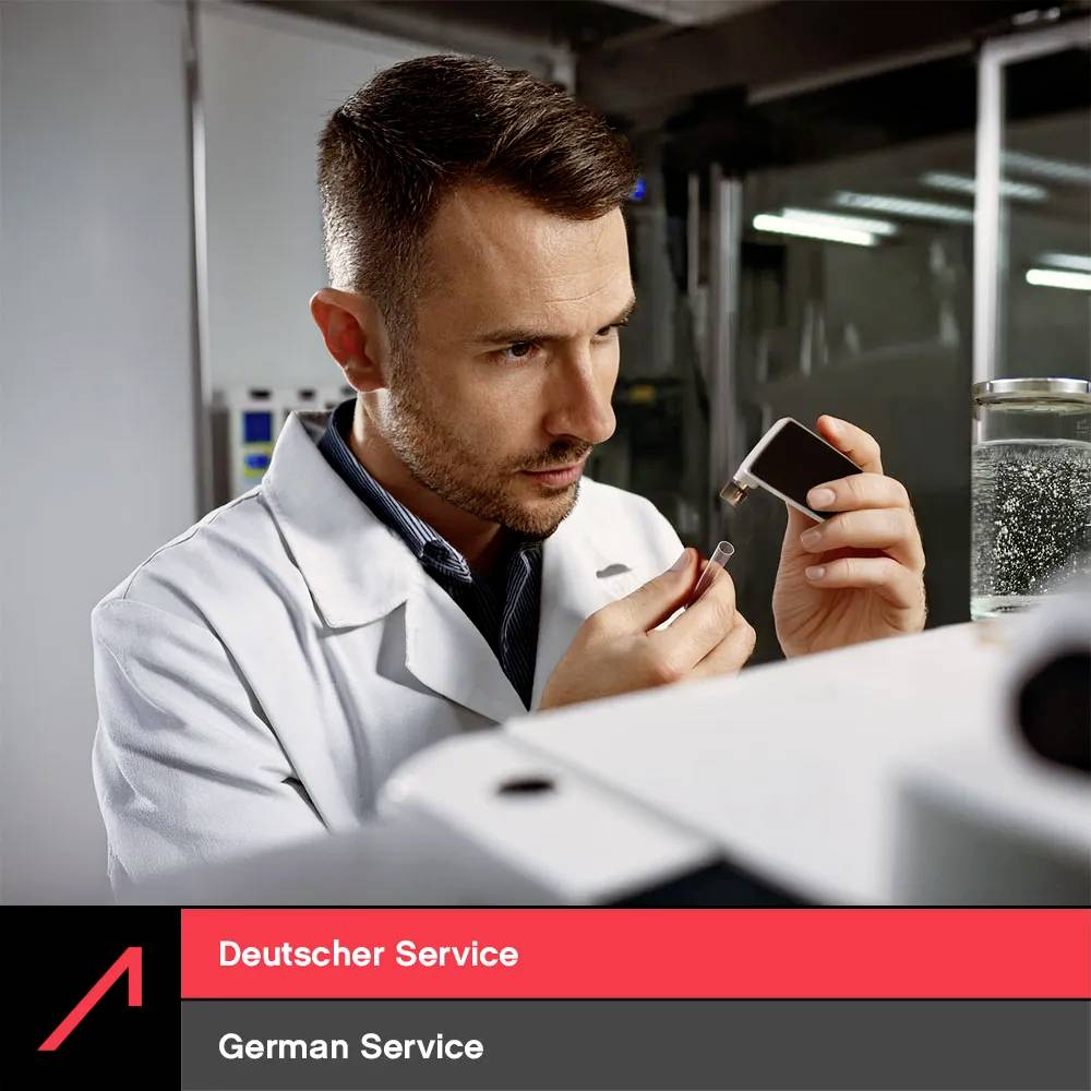 A man in a lab coat examines a small electronic device closely, focused on its components. The image emphasizes careful inspection.