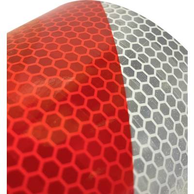 Close-up of a reflective surface with red and gray hexagonal patterns.