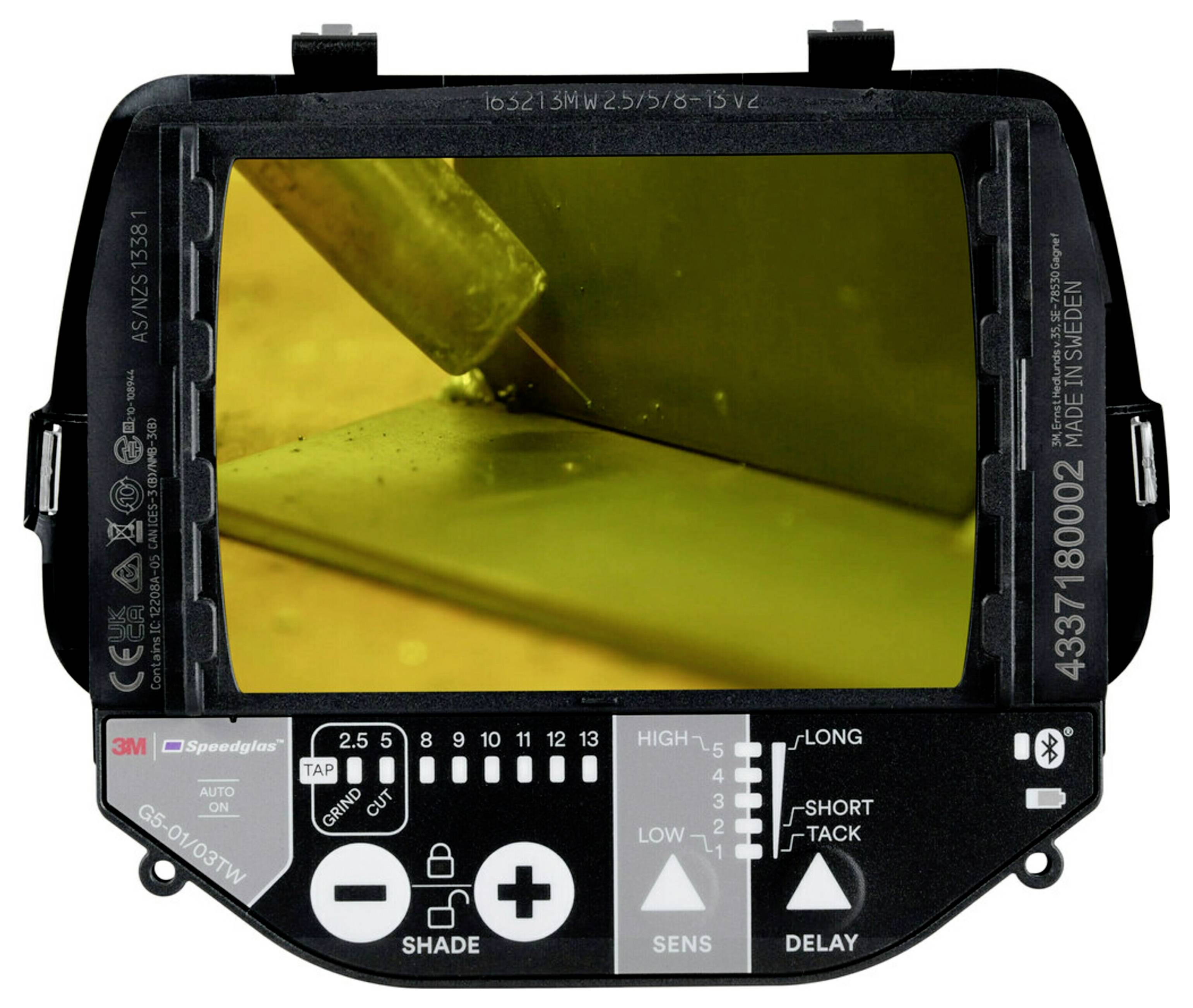 A welding helmet's digital display shows a welding action. The helmet features settings for shade, sensitivity, and delay, enhancing precision.