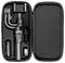 A portable camera stabilizer kit inside a black case, including a gimbal, mini tripod, charging cable, and a light accessory.