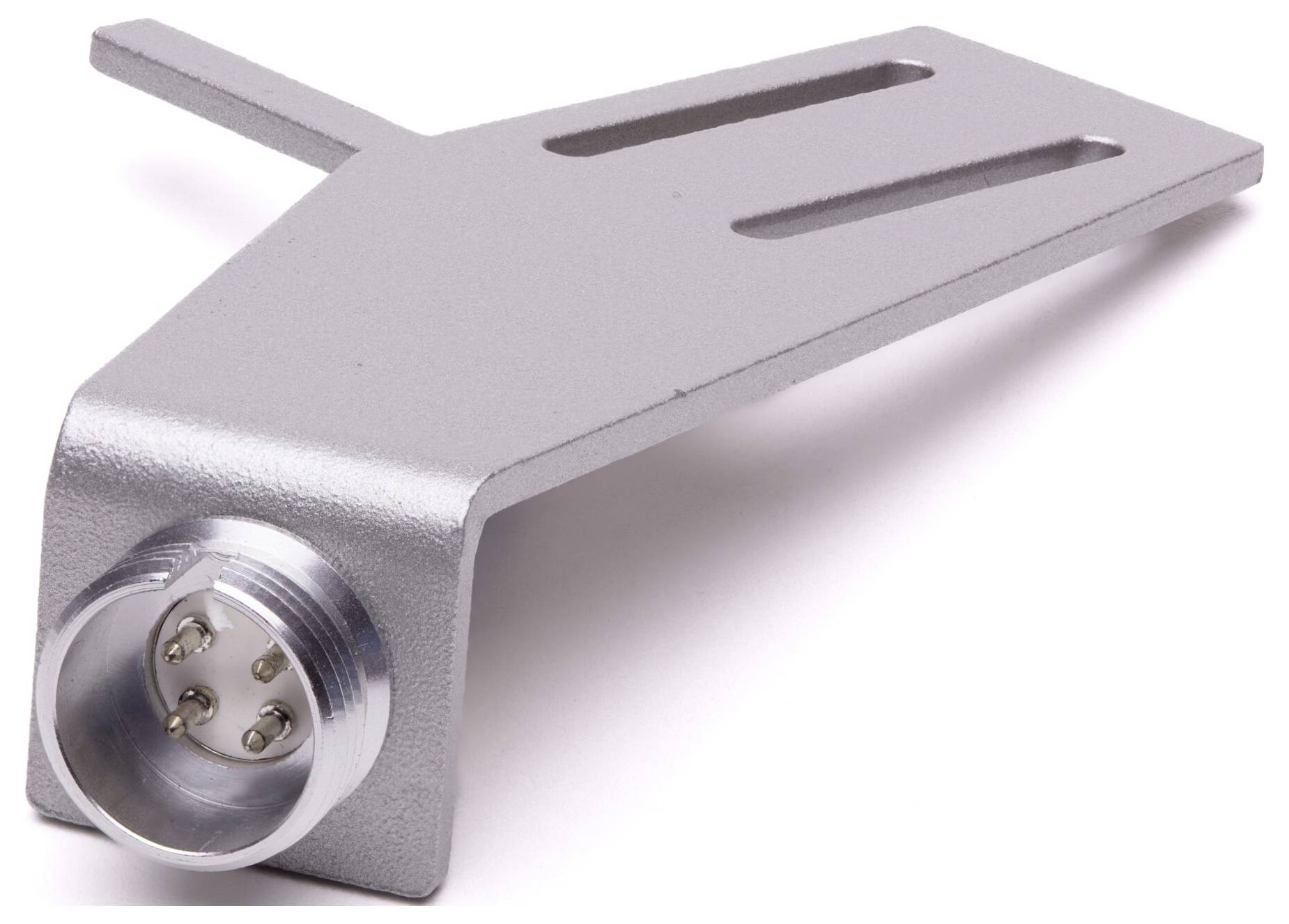 A silver turntable headshell with a metal body and four connection pins. It is designed for attaching to a tonearm for playing vinyl records.