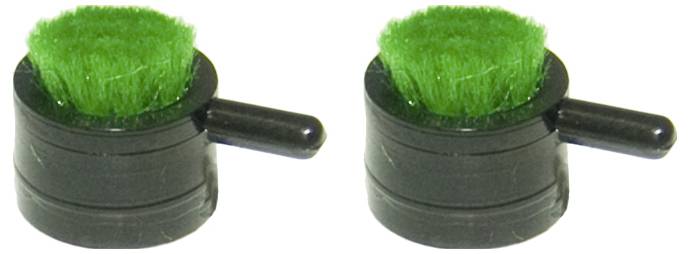 Two small black objects with green bristles and side handles, resembling mini scrubbers, positioned side by side on a white background.