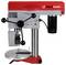 A red and white bench drill press with a metal base and adjustable table, suitable for precise vertical drilling tasks in workshops.