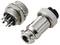 Close-up image of a metal electrical connector with multiple pins and a corresponding plug. The connector has a ribbed grip for securing attachment.