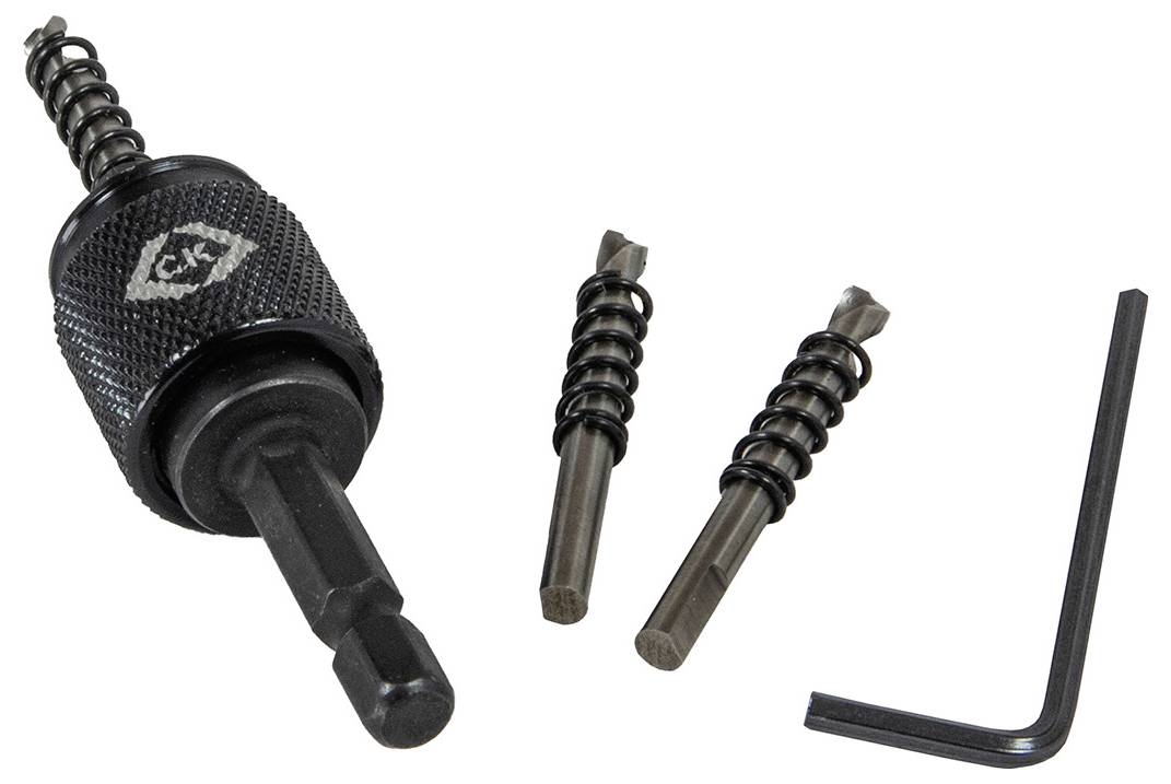 Close-up of a countersink kit including a drill bit, two adjustable countersinks with springs, and a hex key, used for woodworking.