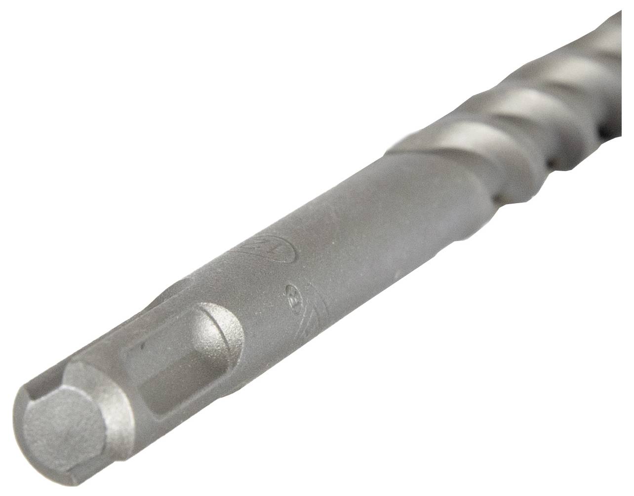 A close-up view of a metal drill bit with a hexagonal shank, showing its spiral flutes for efficient drilling.