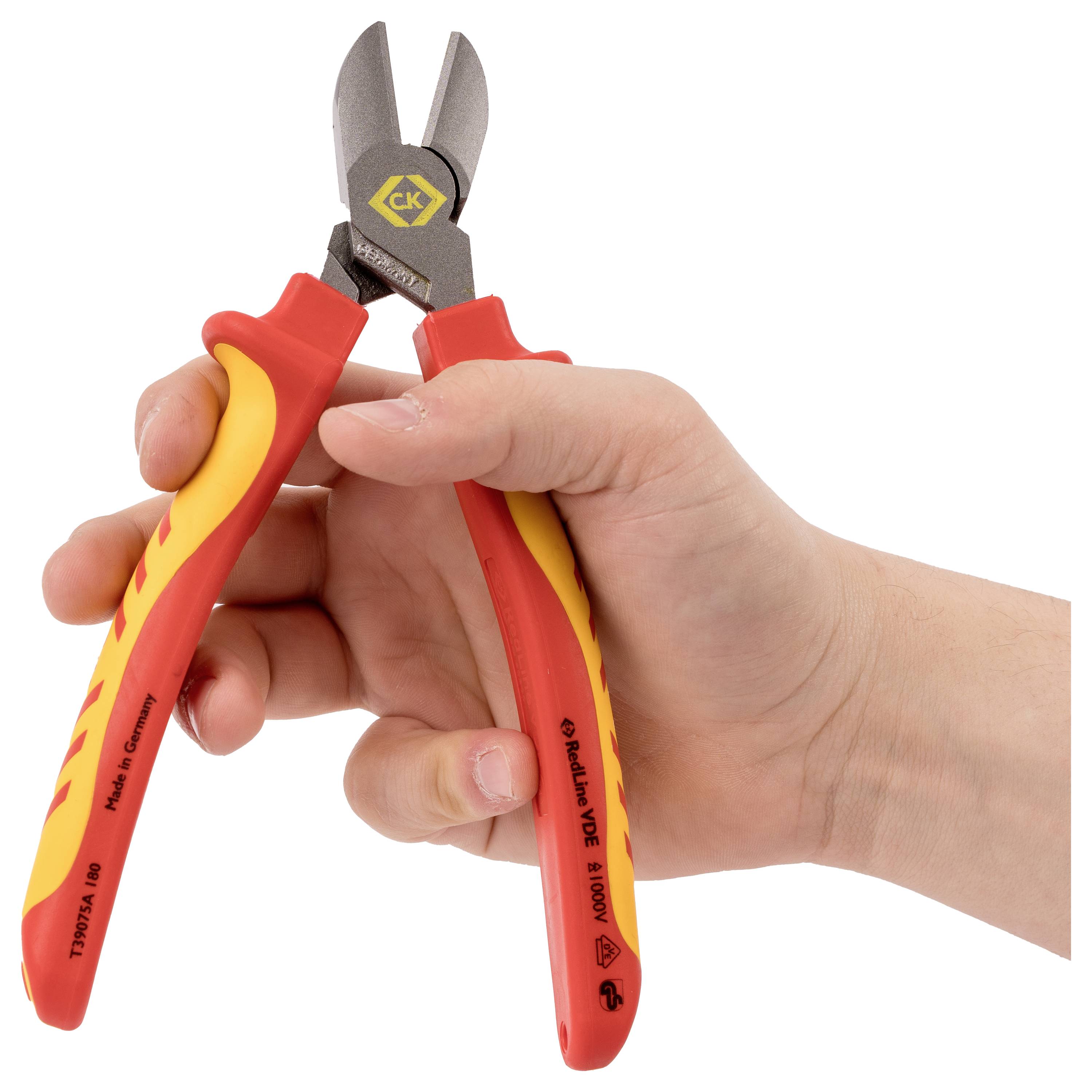 A hand holds insulated wire cutters with red and yellow handles, displaying the tool ready for use in electrical work.