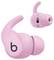 Pink wireless earbuds featuring a sleek design with an ear hook for fit. Black logo 'b' on the side.