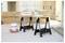 A pile of construction materials, including bags and a bucket, sits on a workbench supported by sawhorses in a partially finished room.