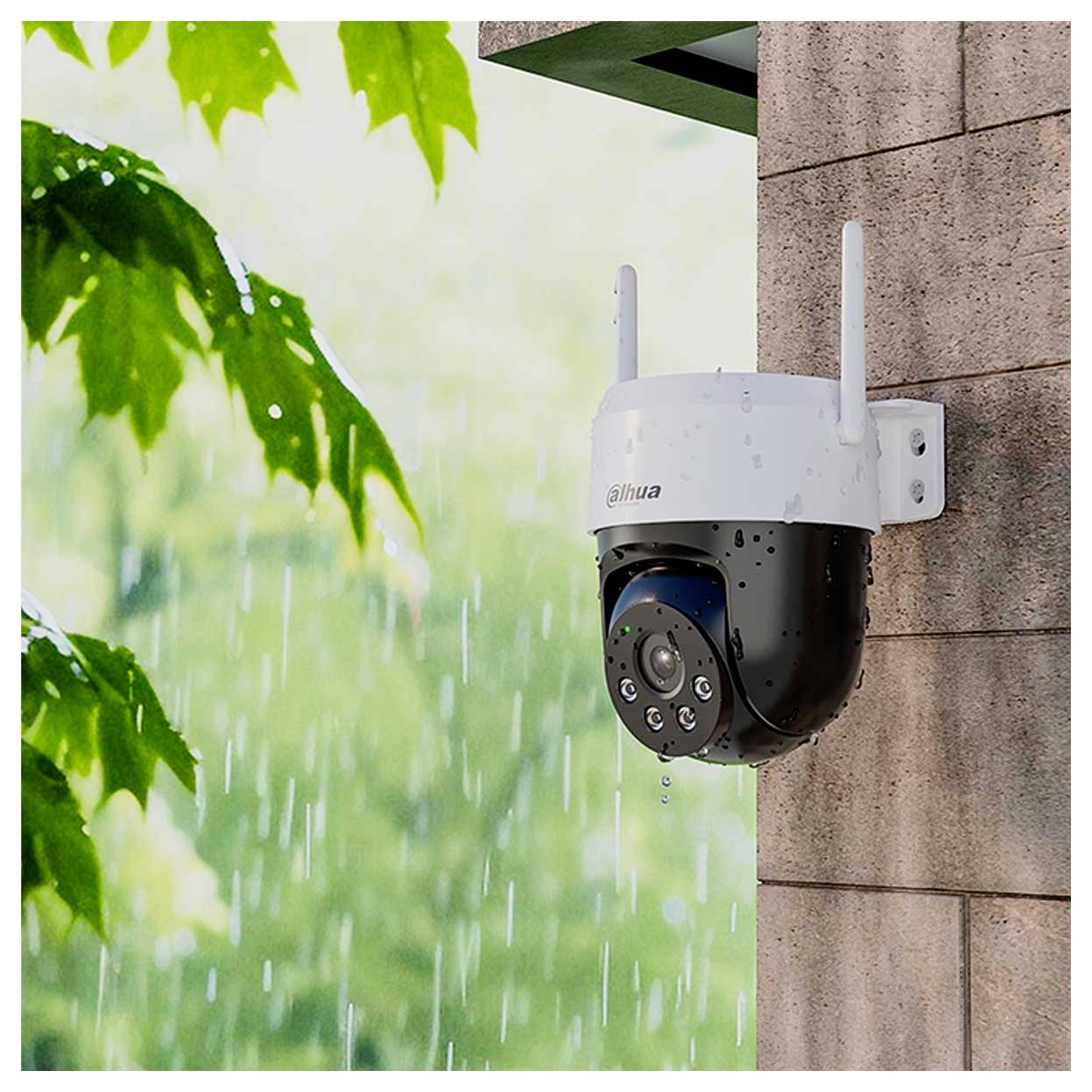 A security camera mounted on a brick wall in the rain, with green leaves in the background.