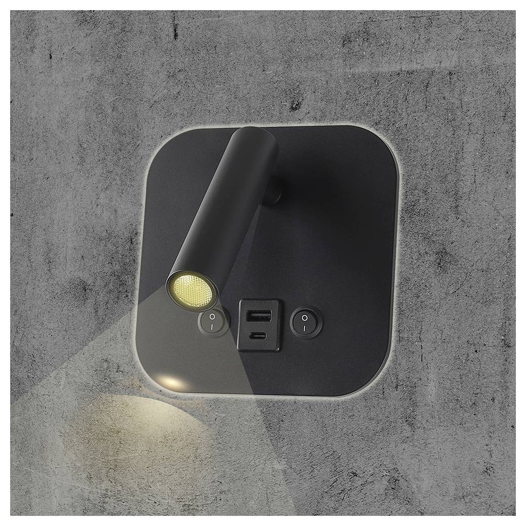 Wall-mounted black lamp with adjustable cylindrical head, two USB ports, and two control buttons. Light projects onto textured gray wall.