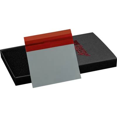 A red and gray thermal pad rests against a black box with a bear logo and 'thermal grizzly' text, indicating a branding for thermal management.