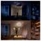 'Two images of the same room: Top shows a dark ambiance with dim lighting; bottom shows the room brightly lit, revealing furniture and decor.'