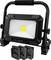 A portable black LED floodlight with a handle, designed for outdoor use. It includes battery compartments at the base.