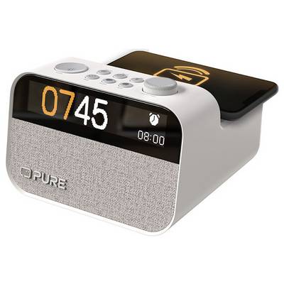 A digital alarm clock with a wireless charging pad on top. The display shows '07:45' and an alarm icon, with the brand name 'PURE' visible.