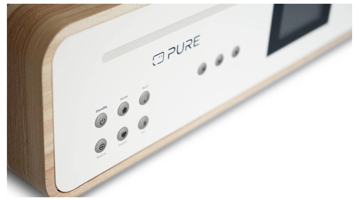 A close-up of a wooden entertainment system with a white front panel featuring control buttons and a small display screen.