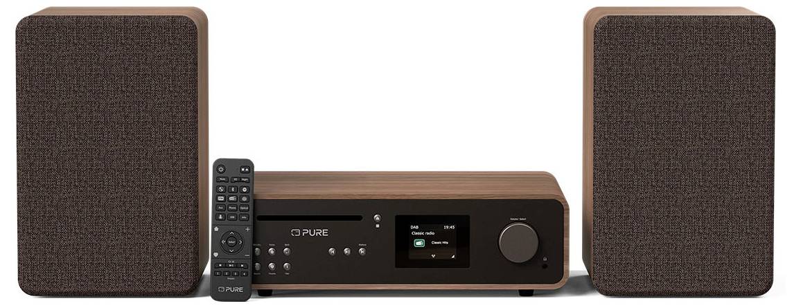 Stereo system with two brown speakers, central unit with display showing music info, and a black remote control in front.