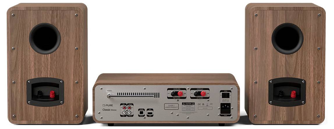 Back view of a wooden stereo system showing two speakers and a central unit. Inputs, outputs, and control knobs are visible on the central unit.