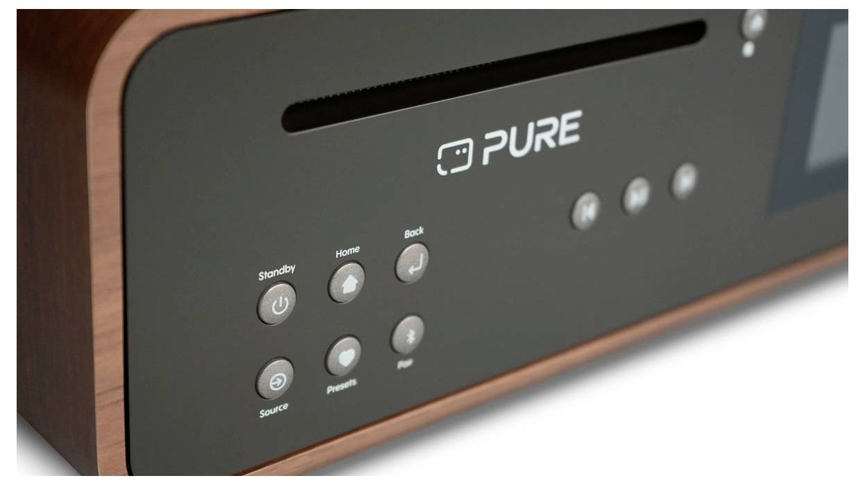 A close-up of a wooden radio or speaker unit displaying a row of buttons and the brand name 'PURE' on the front panel.