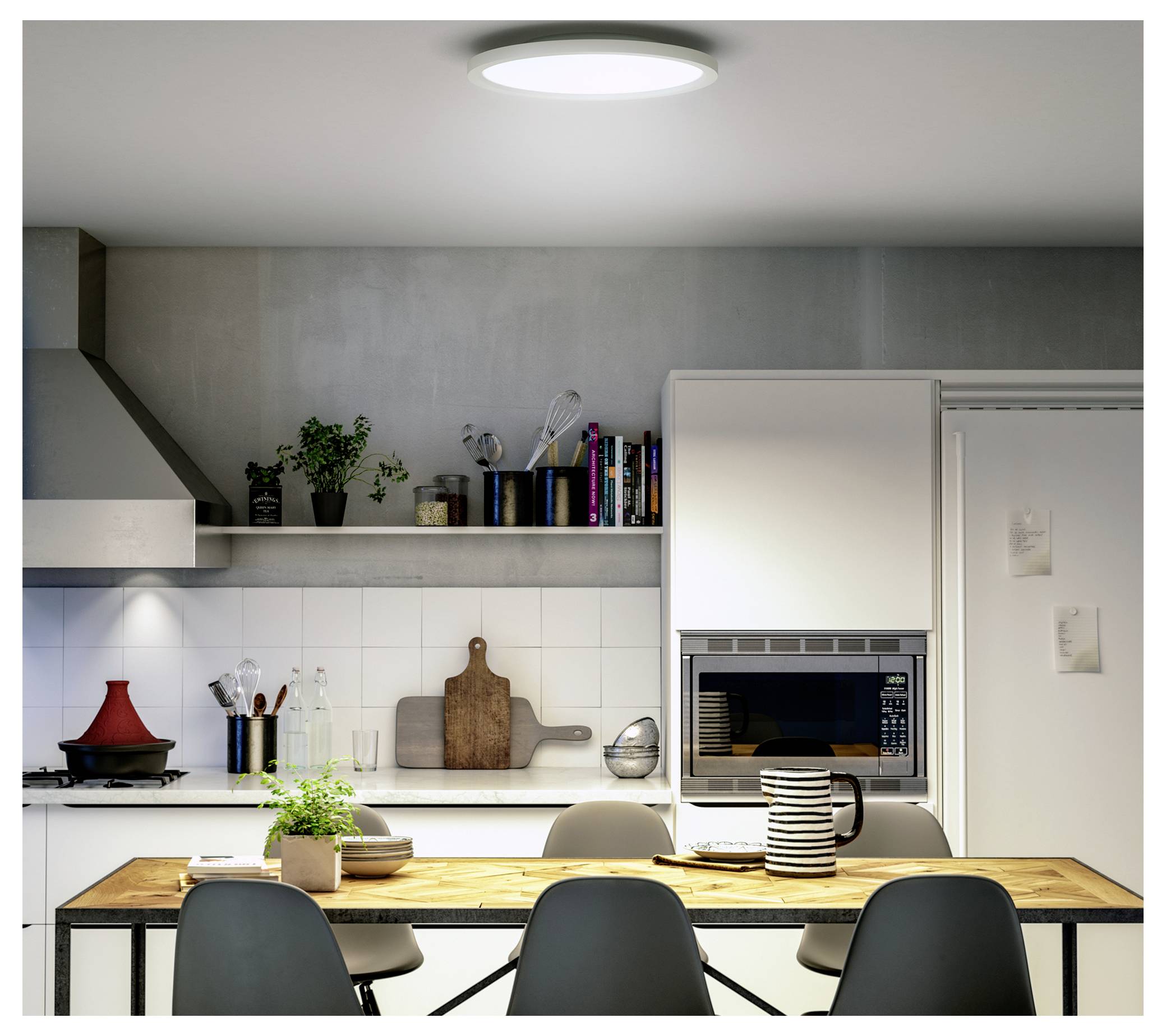Cozy kitchen with wooden dining table, four chairs, modern white cabinets, plants, books on shelves, and overhead lighting.
