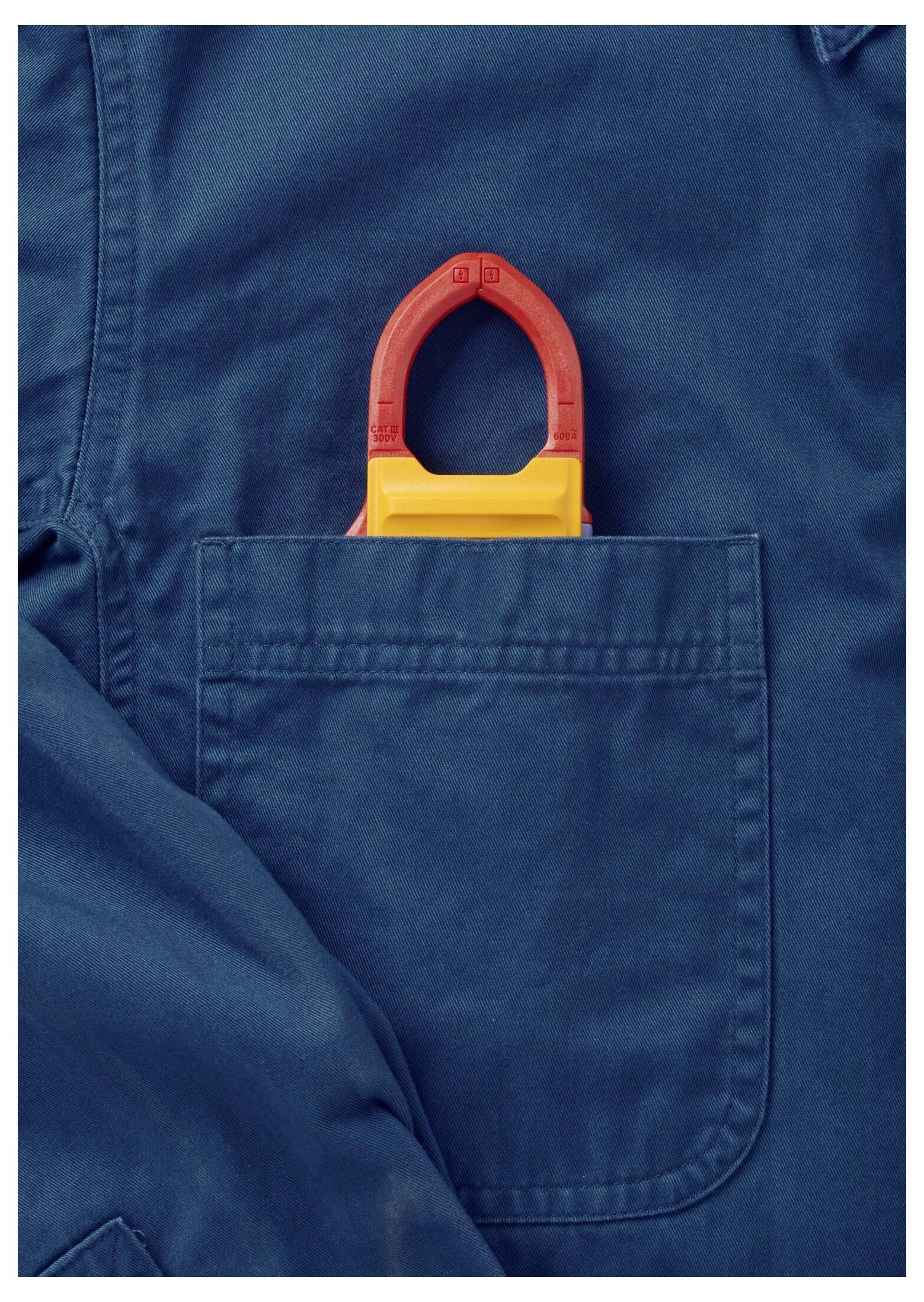 A blue work shirt with a red and yellow lockout tagout device partially visible in the chest pocket, indicating safety precautions.