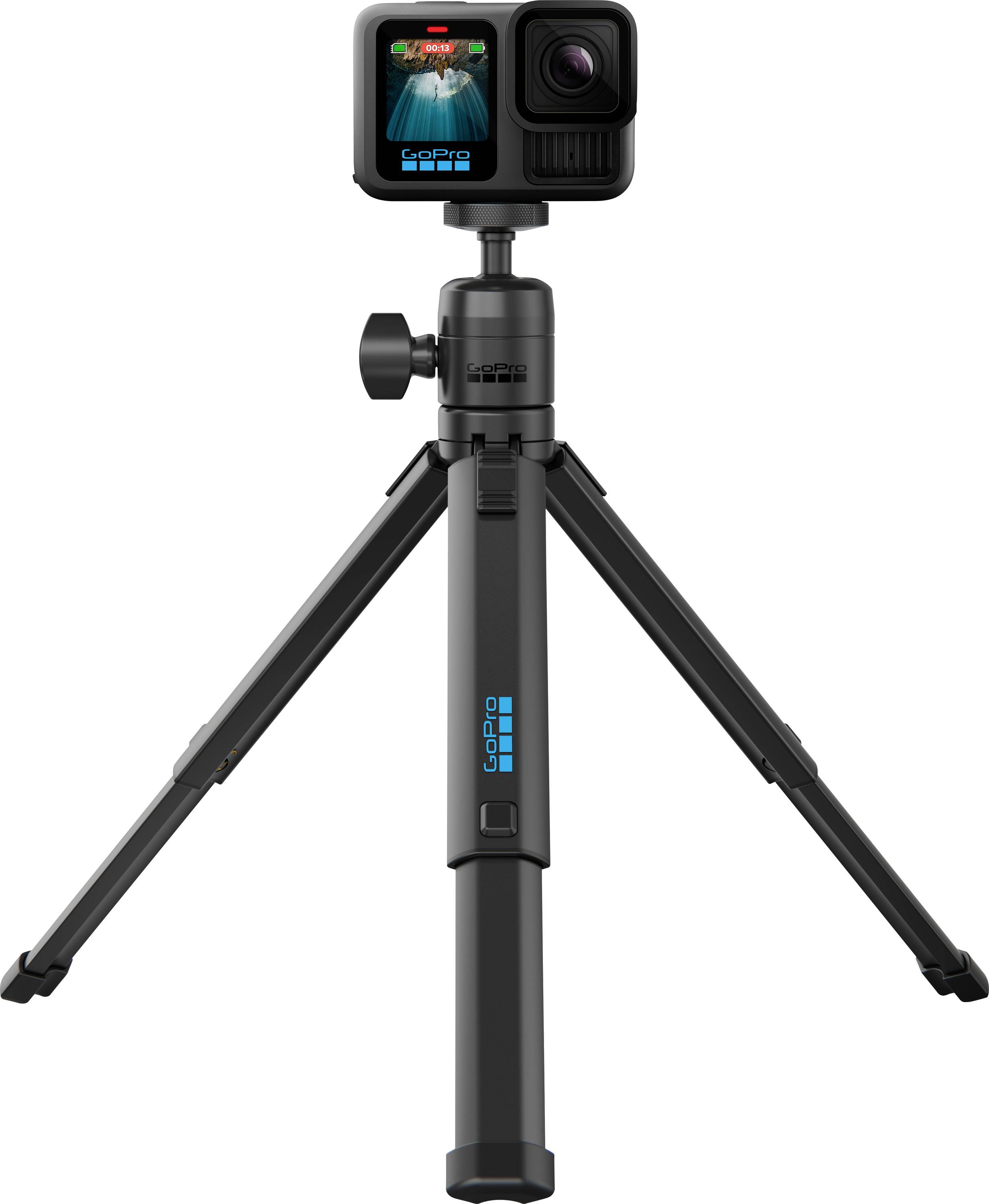 A black action camera mounted on a short tripod. The screen displays a colorful image, indicating it's in use. The setup suggests portability and stability.