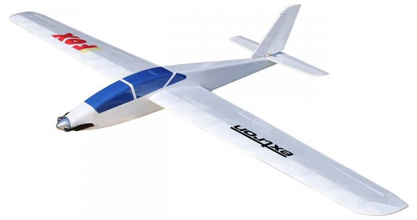 A white and blue model glider with the words 'FOX' and 'EXTRA' on its wings, designed for remote control flight.