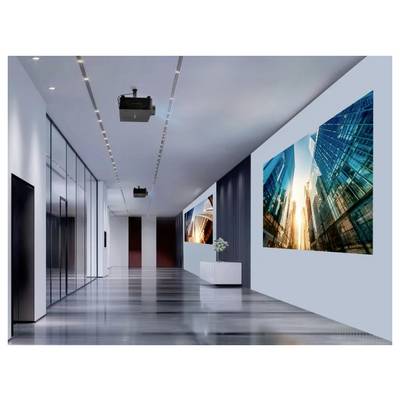 A modern office hallway with sleek design, featuring large digital screens displaying abstract cityscape images and overhead lighting.