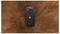 'A rugged black smartphone with a textured back, centered against a dynamic, swirling brown and orange dust background.'