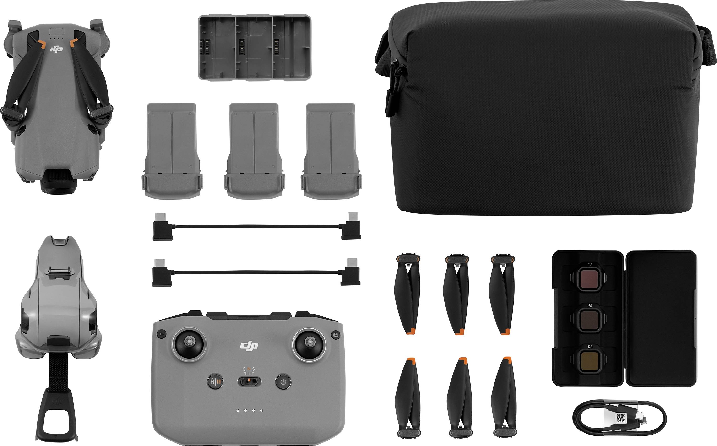 Drone and accessories: drone body, remote control, three batteries, charging hub, carrying bag, propeller blades, and filters.