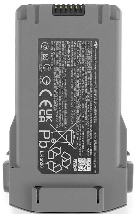 A gray lithium-ion battery with certification marks, safety warnings, recycling symbols, and manufacturer details.