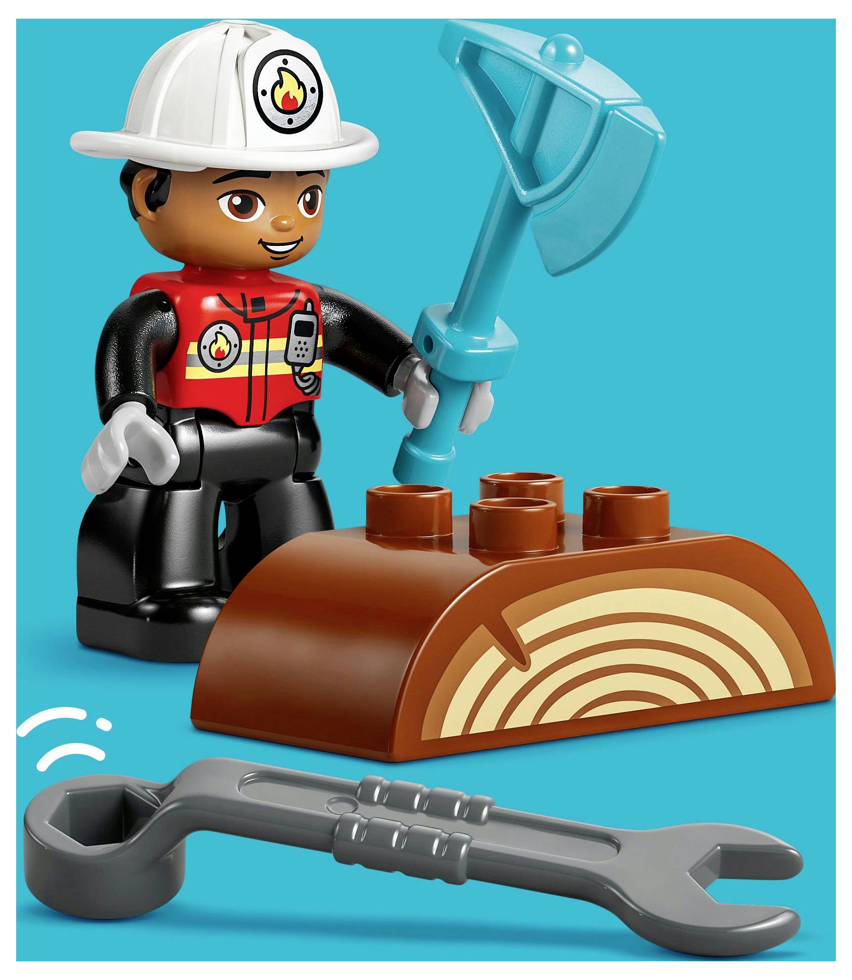 A toy figure dressed as a firefighter with a hard hat stands beside a toy log and an axe, with a toy wrench in the foreground.