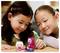 Two young children engage in imaginative play with colorful, small toy figures on a table, focusing intently on their activity.