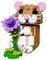 A toy hamster made of interlocking bricks holds a purple flower and stands on a small green base.
