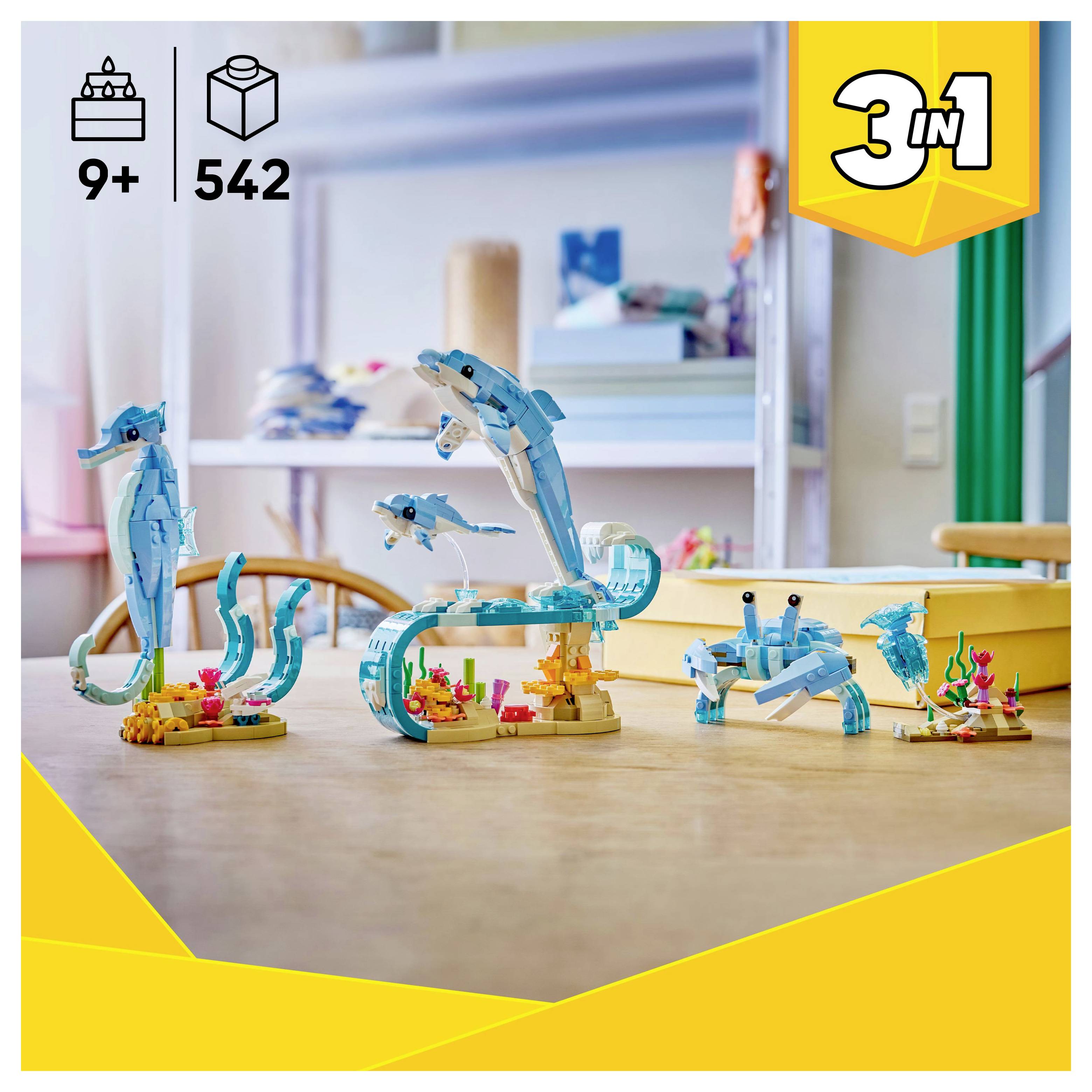 Toy building set on a table showing three sea creatures: a dolphin, seahorse, and crab. Labeled '3 in 1' with age 9+ and 542 pieces.