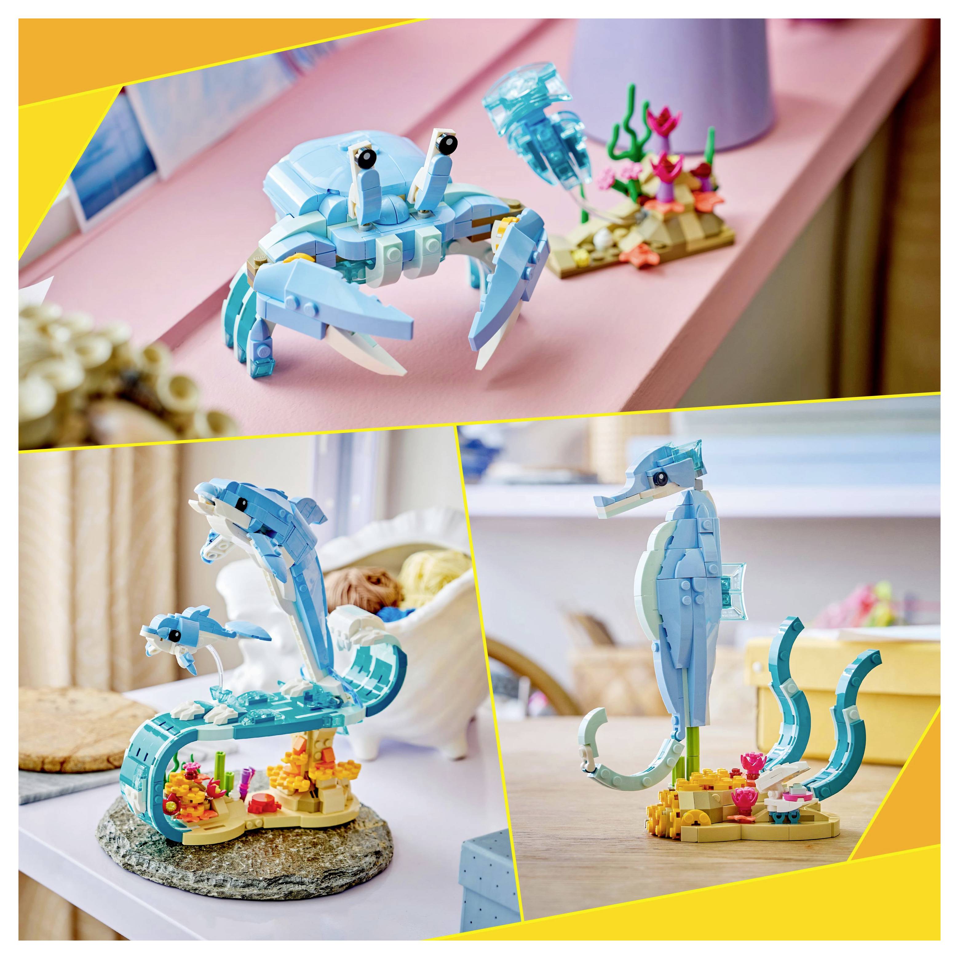 Toy models of a crab, dolphin, and seahorse made from interlocking plastic bricks in a colorful aquatic-themed setting.