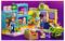 Two children play in a colorful toy supermarket with a cart, produce, and a playful dog. Bright purple background enhances the scene.