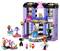 A colorful toy fashion studio with two figures, fashion accessories, a stage with lights, and various styling tools.