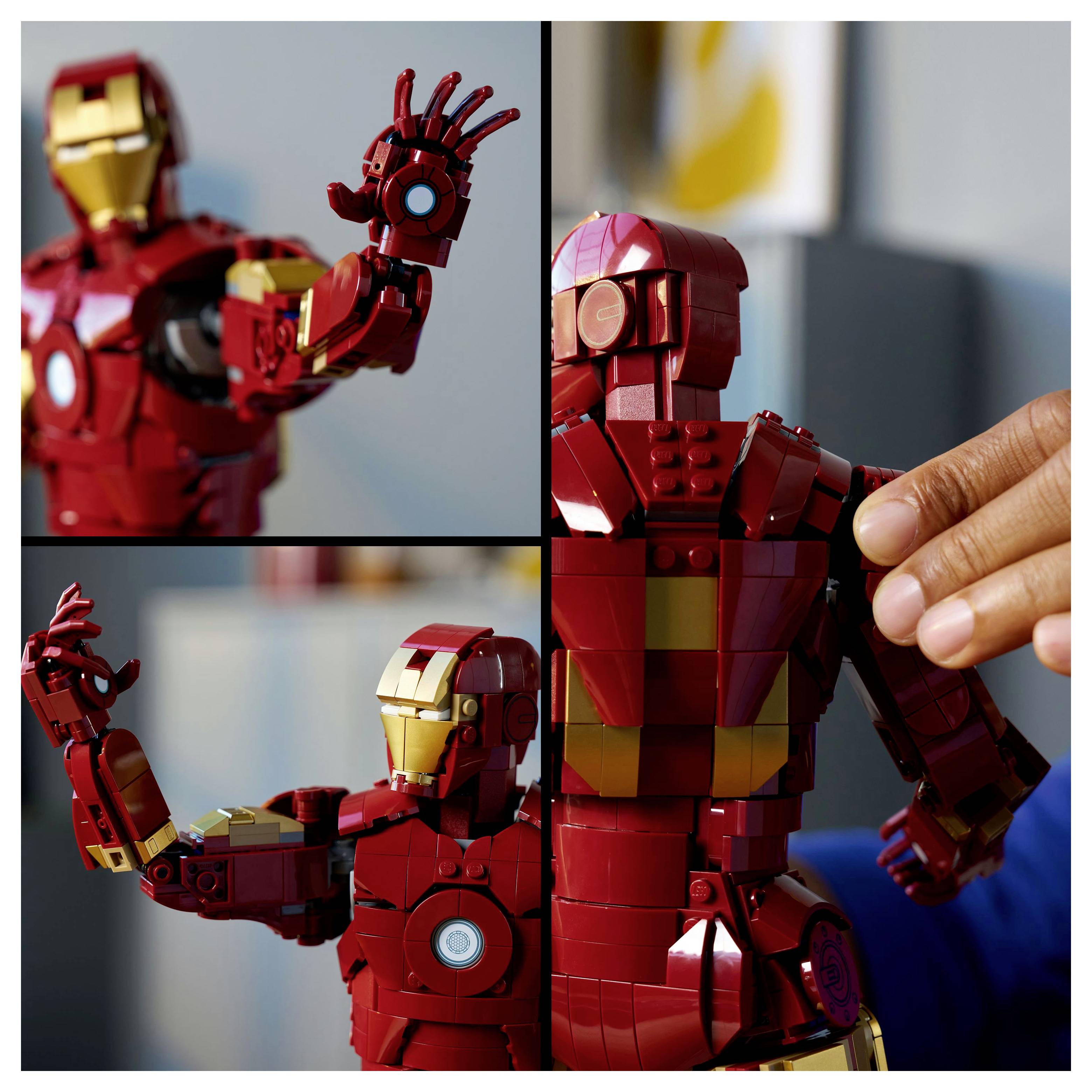 A person assembles a red and gold robot model with articulated joints, resembling a superhero suit. The setting is indoors with blurred background.